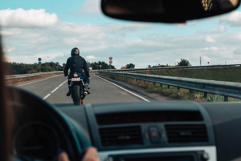motorcycle rider, seen from the perspective of a car driver