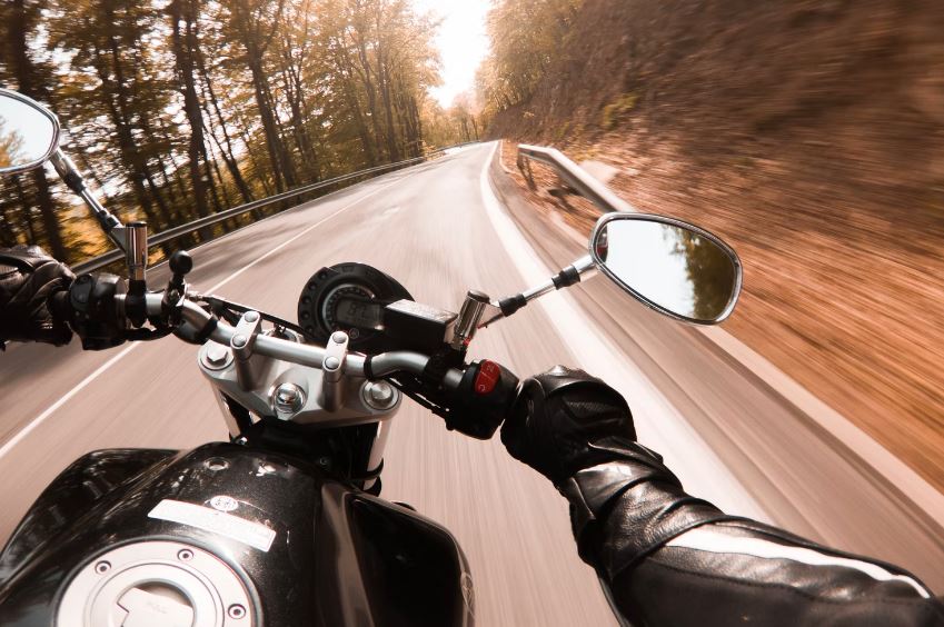 first-person view of a motorcycle rider on an empty road