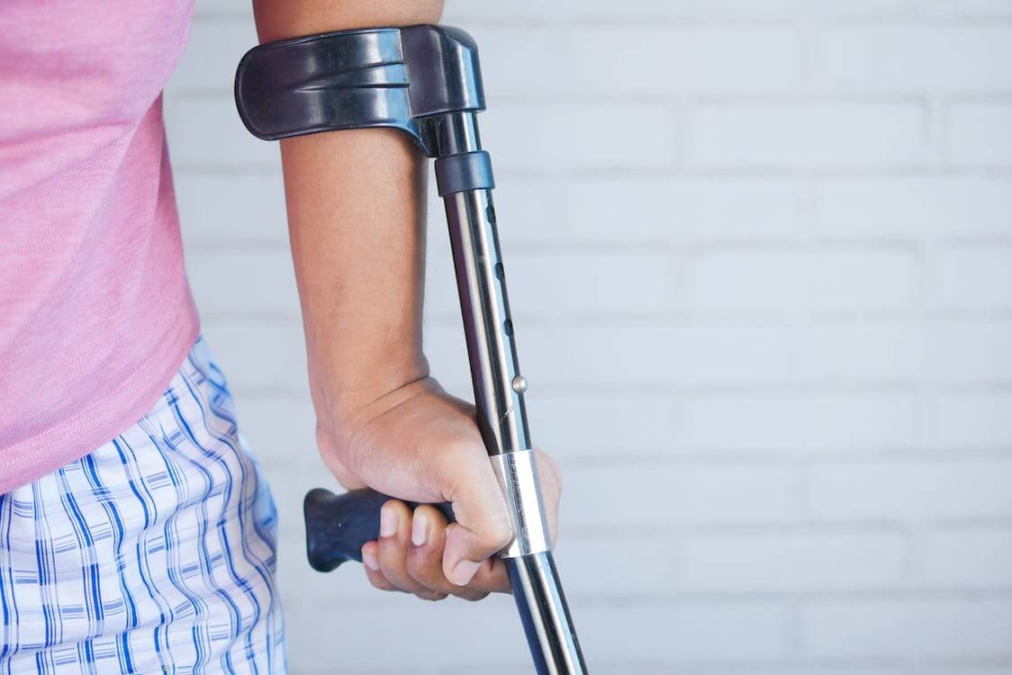 person holding walking crutch