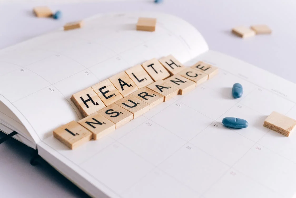 health insurance written with scrabble tiles on a planner