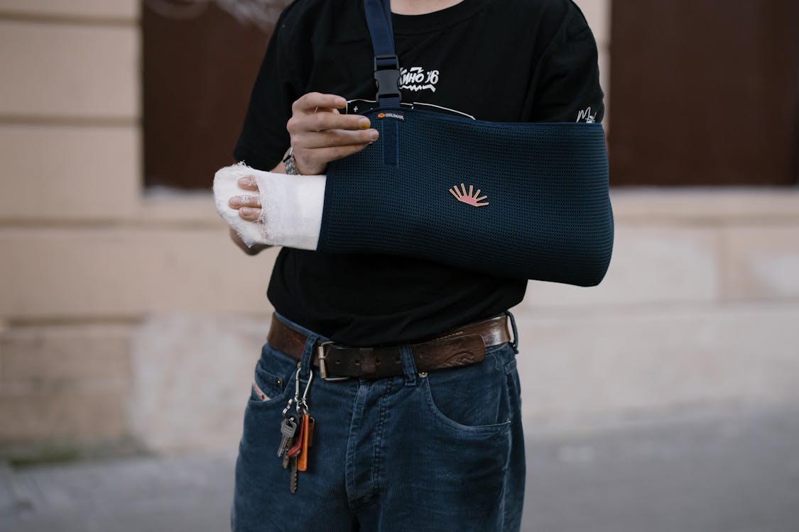 injury victim with bandaged arm in sling