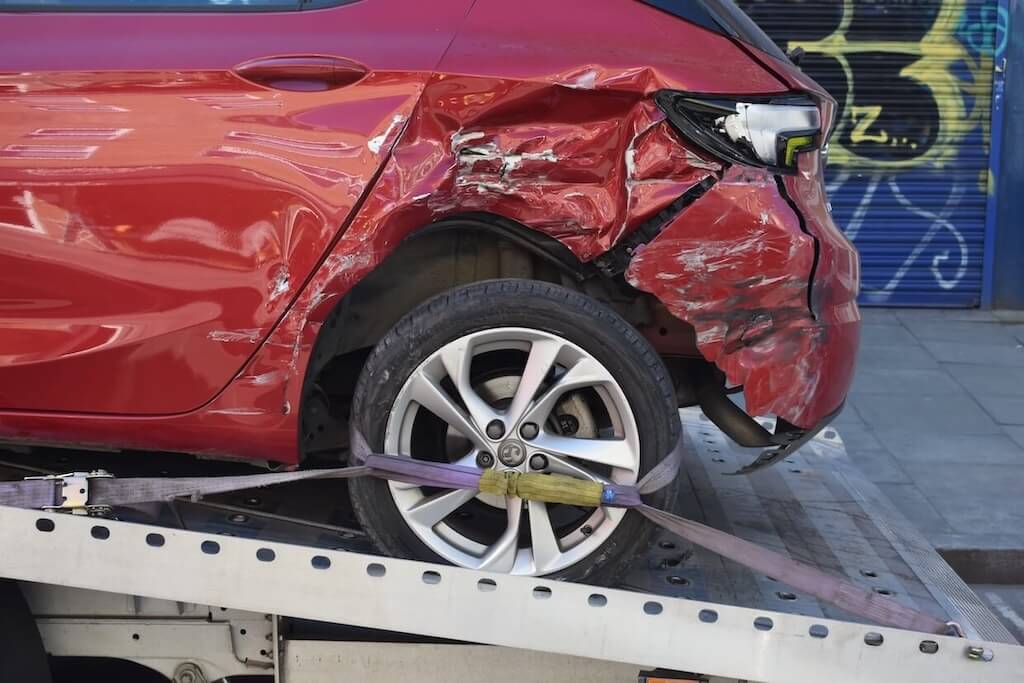 damaged car on flatbed tow truck