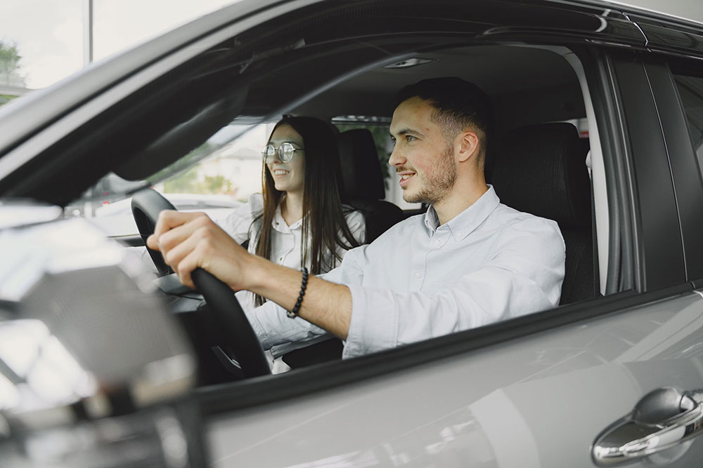 Two people sitting in a car, driving
