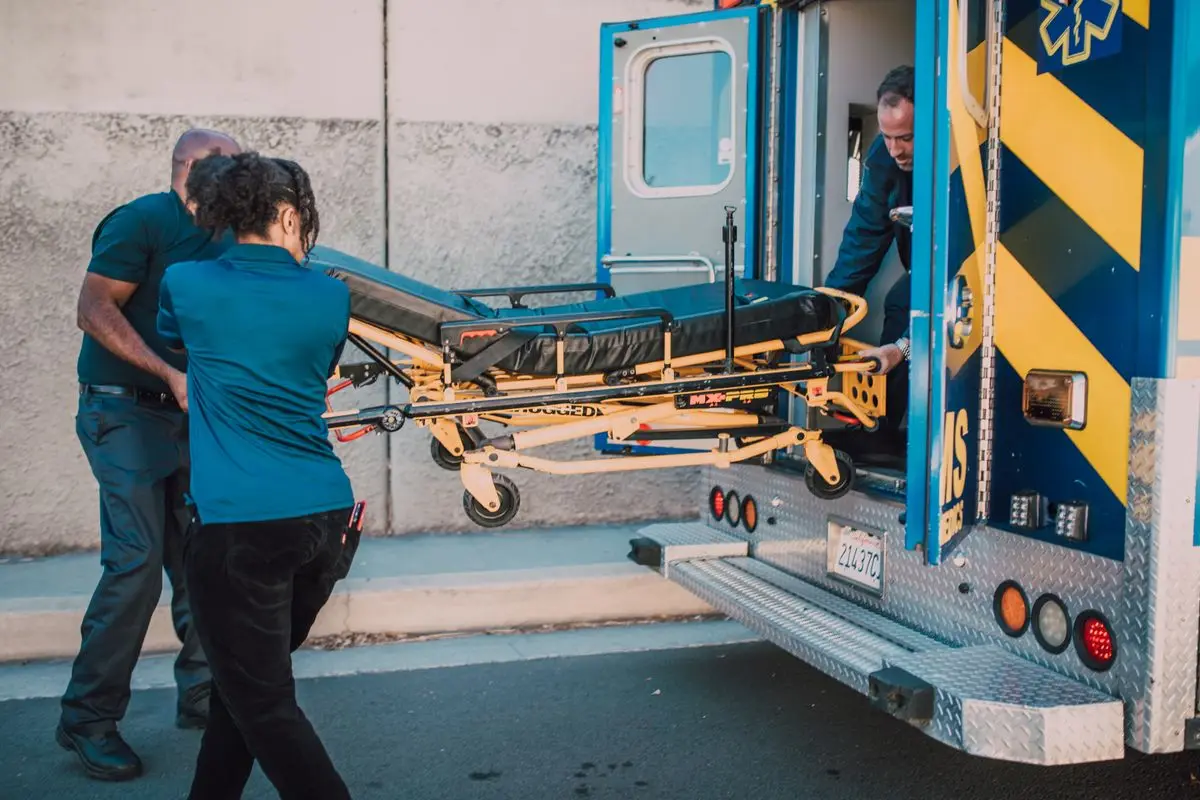 Photo of paramedics pulling a stretcher out of the ambulance